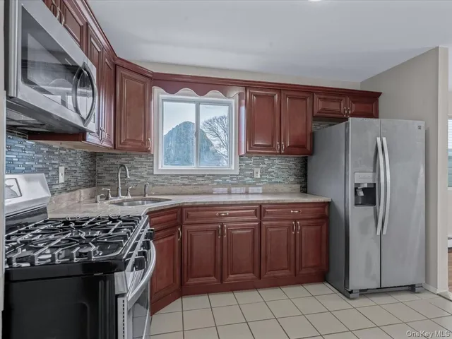 a kitchen with a stove sink and refrigerator