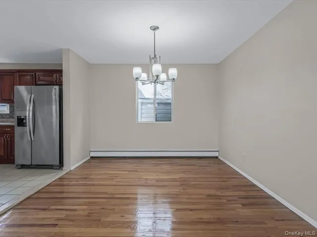 a view of a room with wooden floors closet and windows