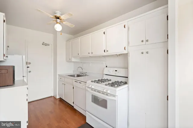 a kitchen with cabinets appliances and a counter space