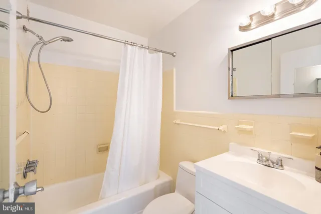 a bathroom with a sink vanity mirror and shower