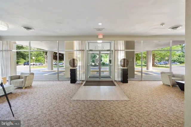 a living room with furniture and large windows