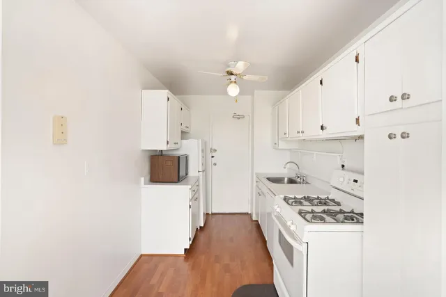 a kitchen with stainless steel appliances a stove a sink and a refrigerator