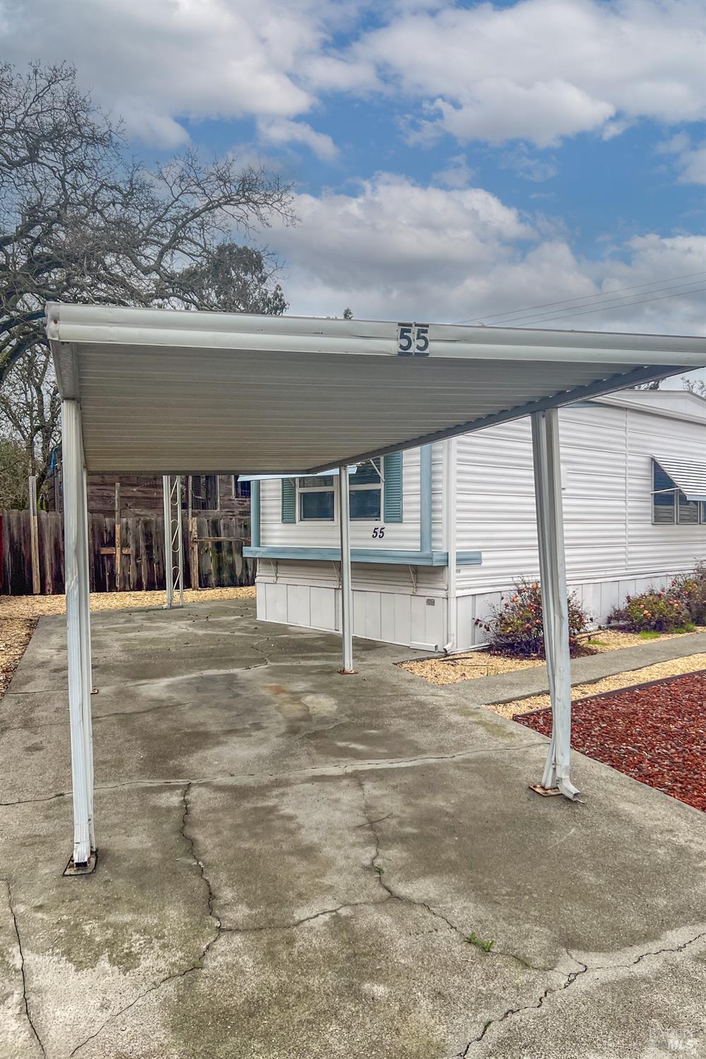 55 Plymouth Way Santa Rosa, CA 95403 - Photo 2 of 19 Covered carport with home in background.