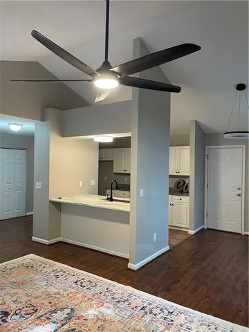 a view of a kitchen with a sink and a refrigerator
