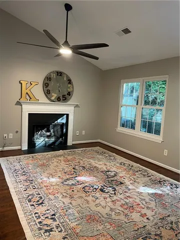a view of empty room with window and fireplace