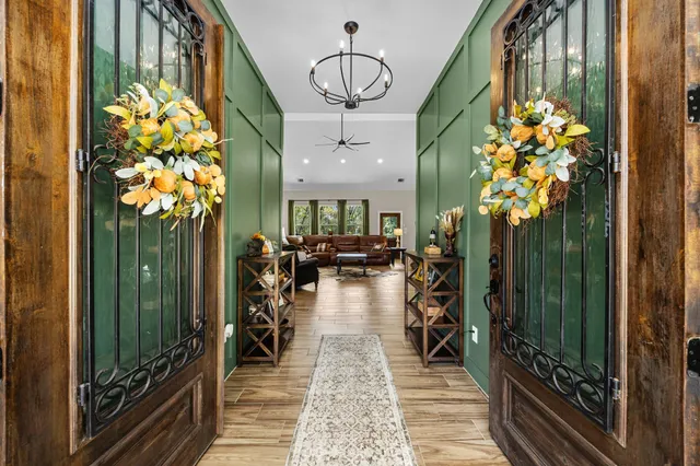 a front view of a house with swimming pool and chairs