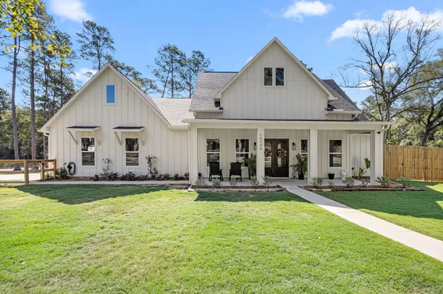 a front view of a house with swimming pool and chairs
