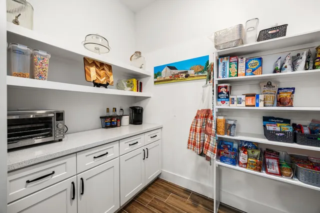 a bathroom with a tub a sink and mirror