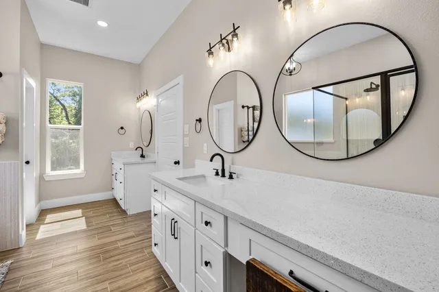 a bedroom with bed and wooden floor