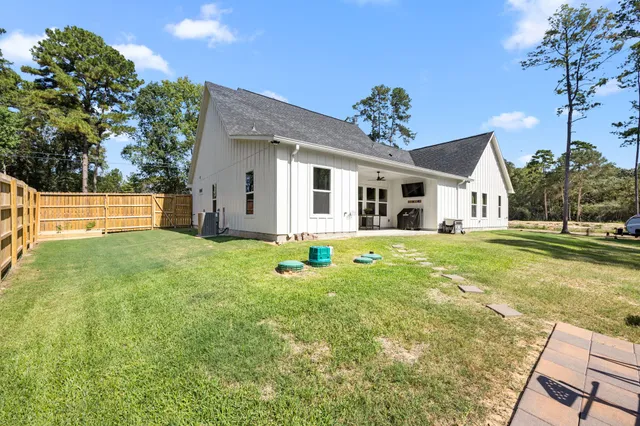 a view of a house with a yard and sitting area