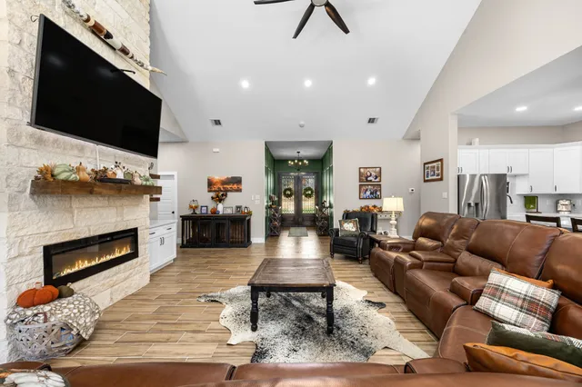 a kitchen with stainless steel appliances a stove a sink a center island and cabinets