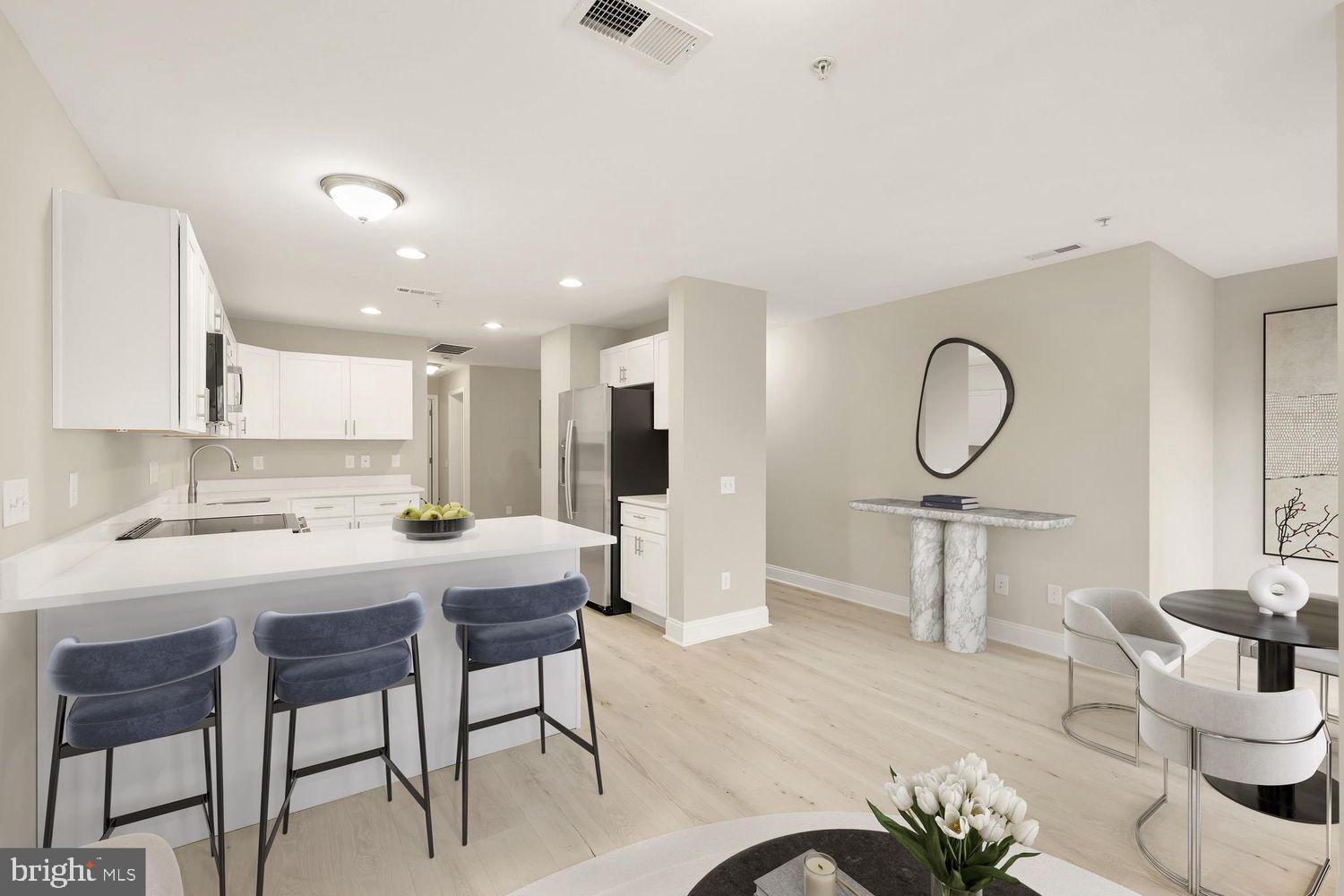 a kitchen with a table chairs sink and cabinets
