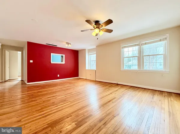 a view of an empty room window and wooden floor