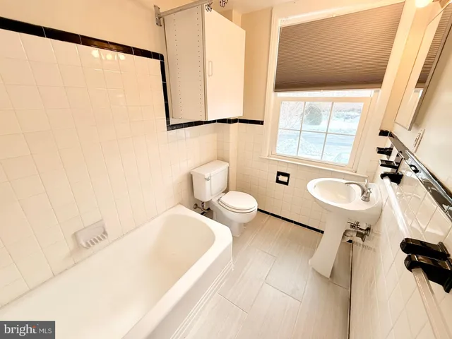 a bathroom with a sink a toilet and tub