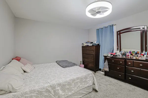 a bedroom with a bed and a mirror