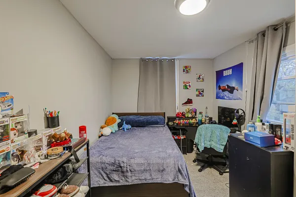 a bed room with a bed and a desk