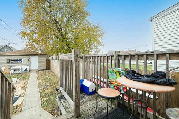 a front view of a house with patio furniture and wooden floor
