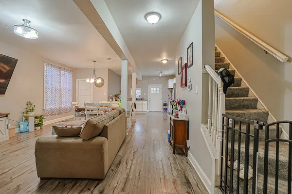 a living room with furniture and a wooden floor