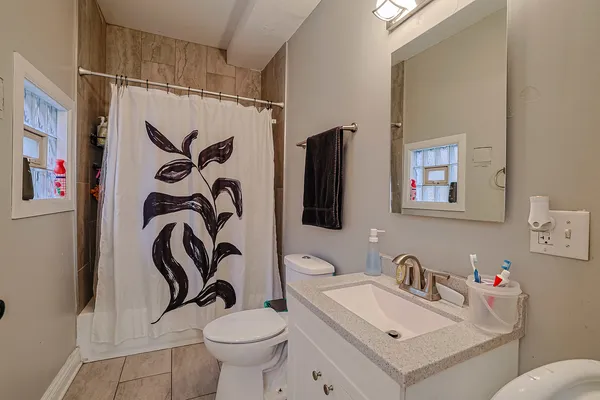 a bathroom with a sink toilet and a mirror