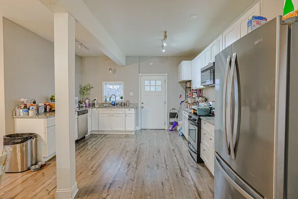 a kitchen with a refrigerator a sink and cabinets