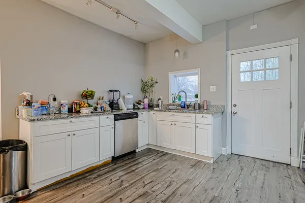 a kitchen with a sink window and cabinets