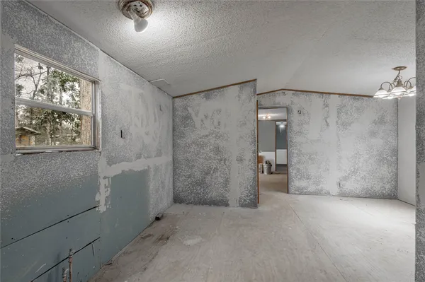 a view of an empty room with a bathroom