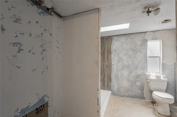 a view of bathroom with shower and a sink