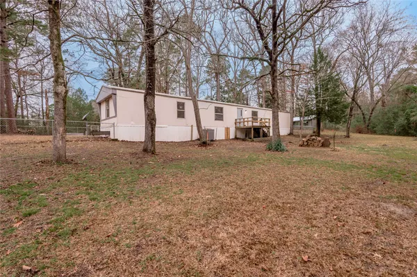 a view of a house with a yard covered in snow