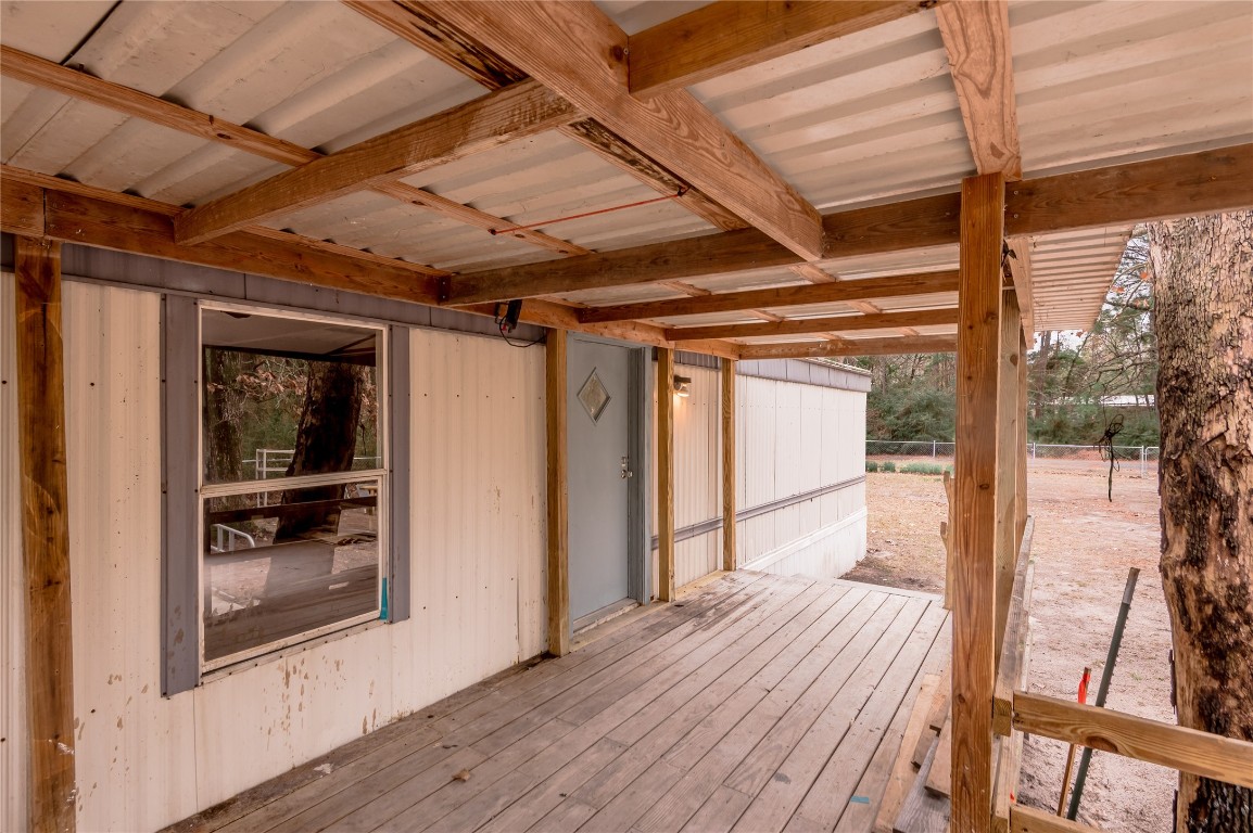 163 Magnolia Court Trinity, TX 75862 - Photo 6 of 25 a view of a porch with wooden floor and furniture