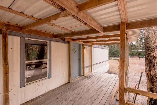 a view of a porch with wooden floor and outer view