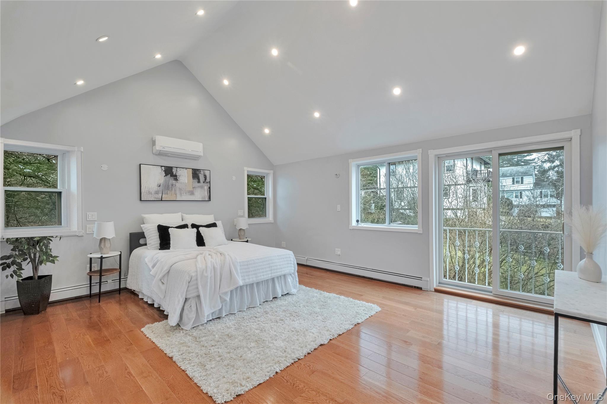 193 Nelson Road Scarsdale, NY 10583 - Photo 16 of 37 a spacious bedroom with a large bed and a large window