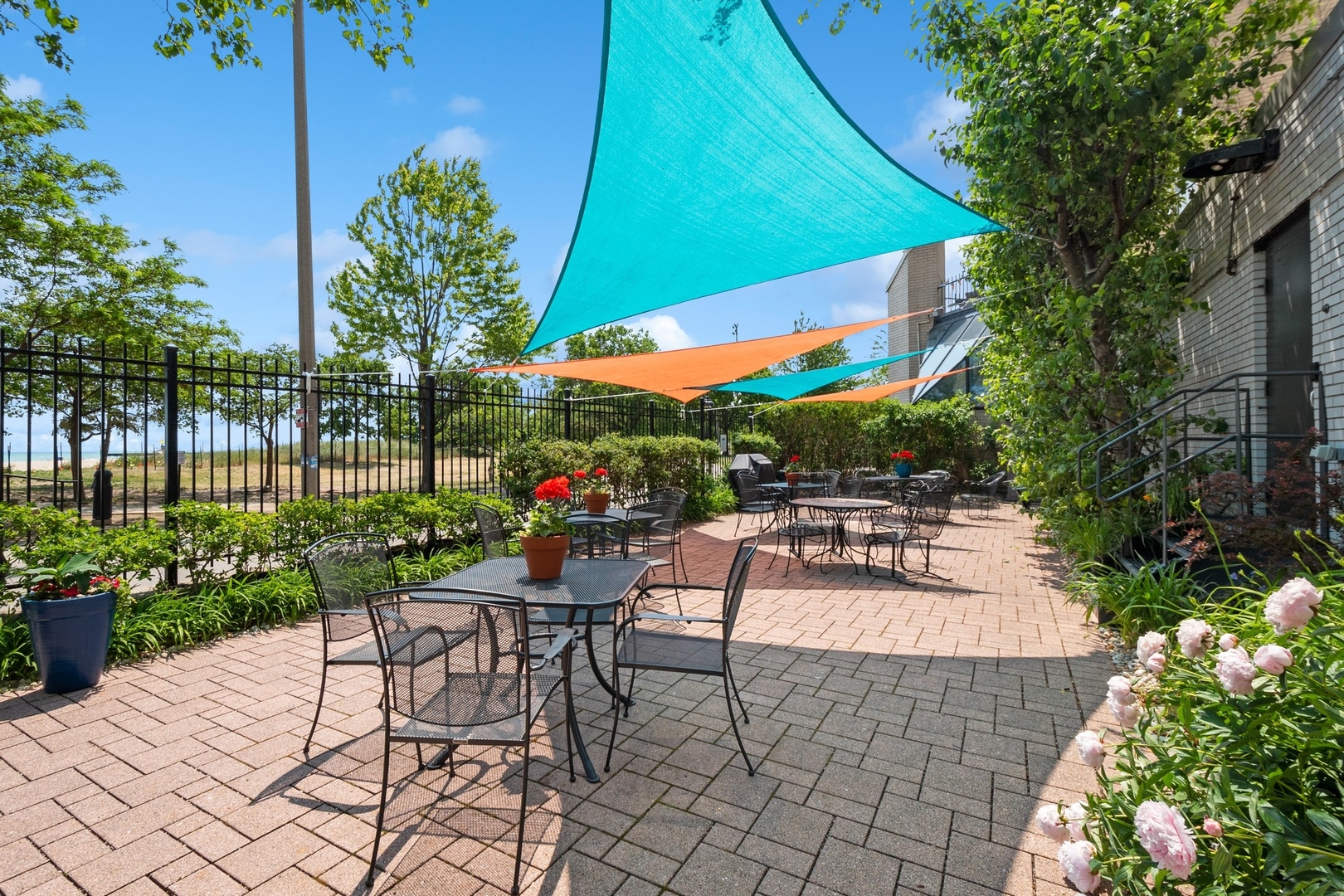 5757 North Sheridan Road, Unit 15G Chicago, IL 60660 - Photo 13 of 18 a view of a patio with a table and chairs under an umbrella