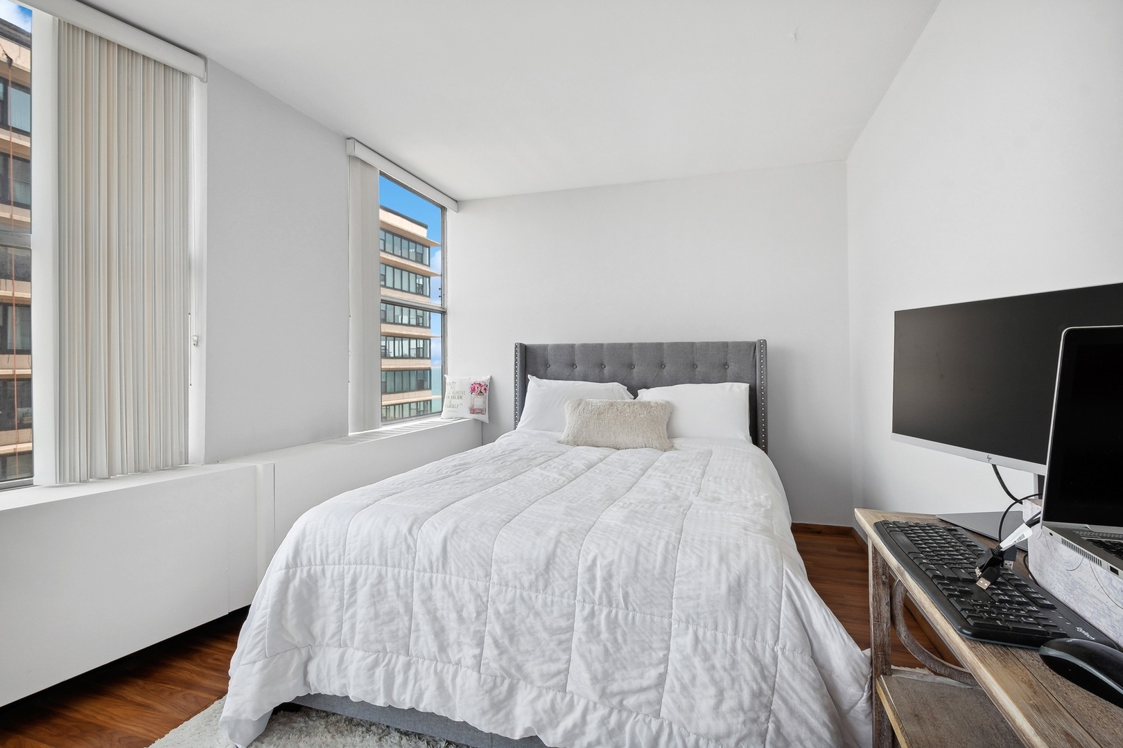 5757 North Sheridan Road, Unit 15G Chicago, IL 60660 - Photo 9 of 18 a bedroom with a bed and a flat screen tv