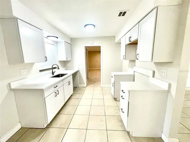 a kitchen with a sink cabinets and appliances