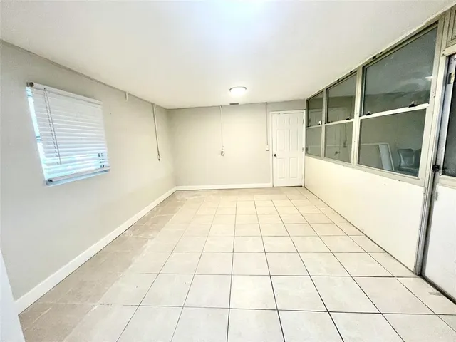 a view of an empty room and a window