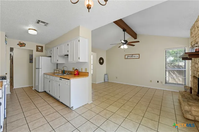 a kitchen with a sink and a refrigerator