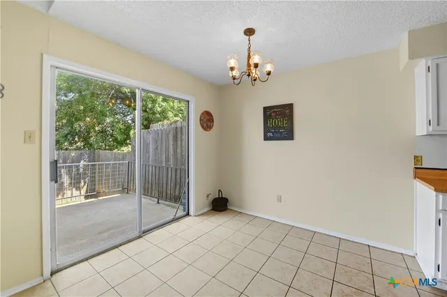 a view of an empty room with glass door