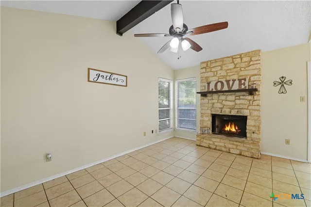 a view of an empty room with a fireplace