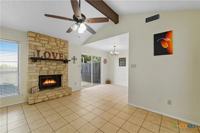 a view of a livingroom with a fireplace and fan