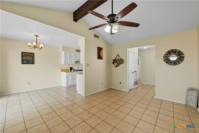 a view of a livingroom with wooden floor and a ceiling fan