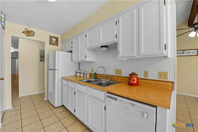 a kitchen with stainless steel appliances granite countertop a refrigerator sink and cabinets