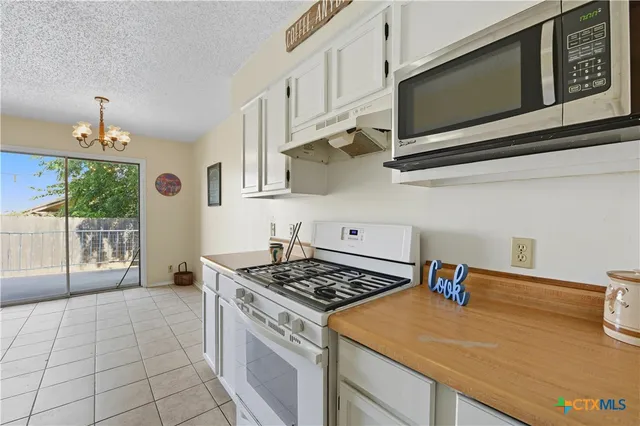 a kitchen with stainless steel appliances granite countertop a stove and a microwave