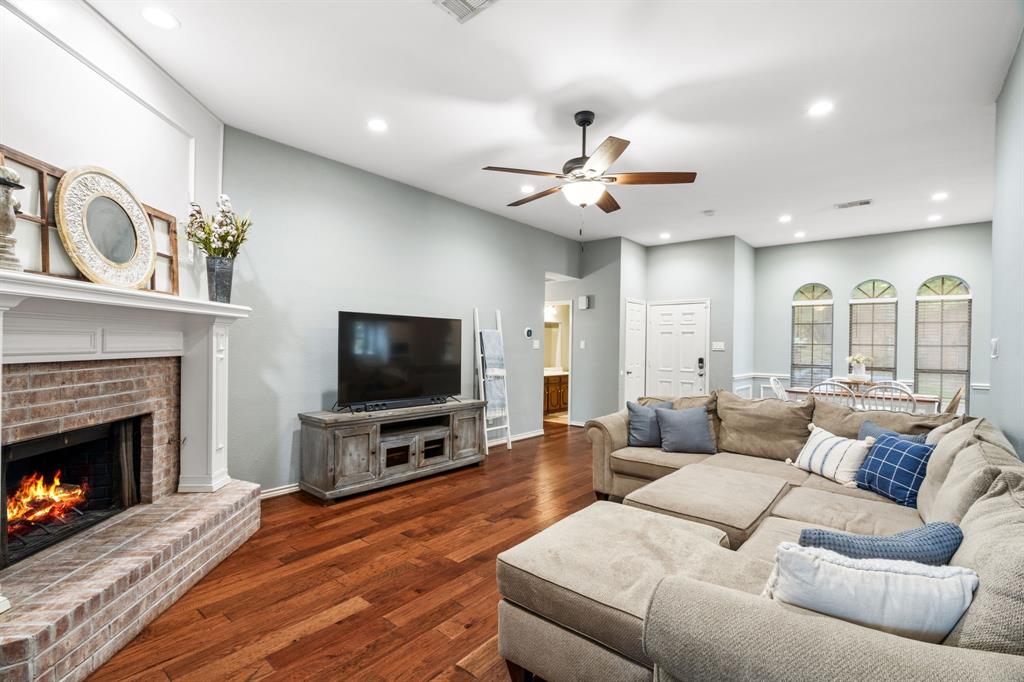 2302 Randi Road Rowlett, TX 75088 - Photo 3 of 33 a living room with furniture a flat screen tv and a fireplace