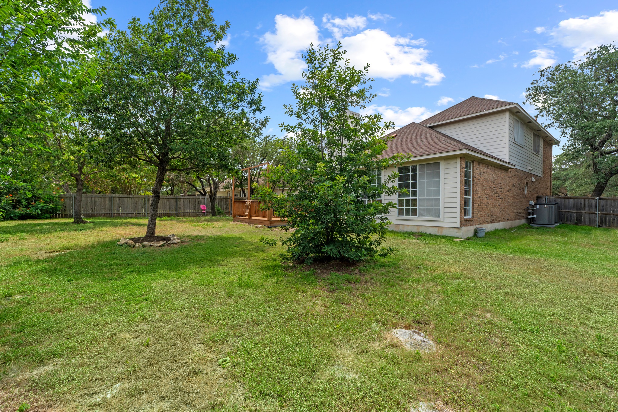 8605 Axis Drive Austin, TX 78749 - Photo 38 of 38 A spacious yard with mature trees and a charming deck awaits.