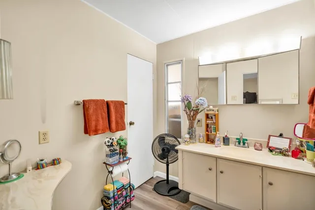 a bathroom with a sink mirror and vanity