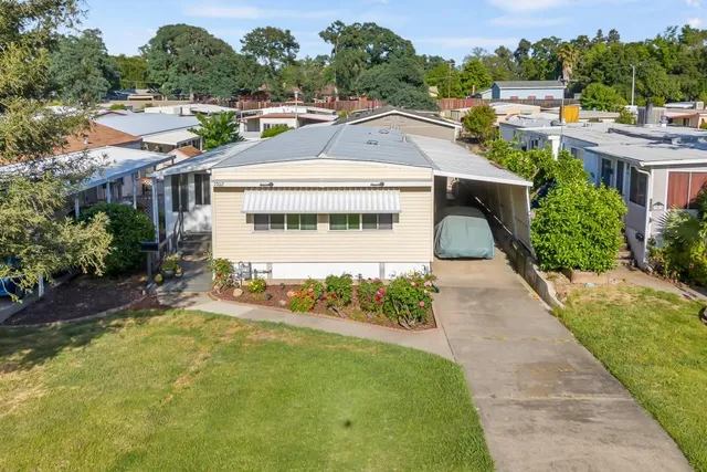 an aerial view of a house with a swimming pool yard and outdoor seating