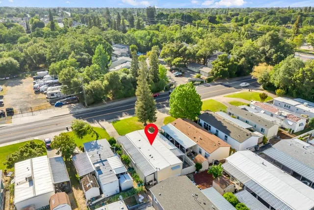 an aerial view of a house with a swimming pool yard and outdoor seating