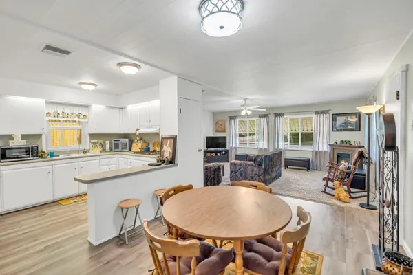 a kitchen with sink a dining table and chairs