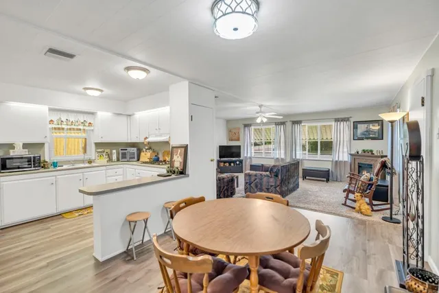 a kitchen with sink a dining table and chairs
