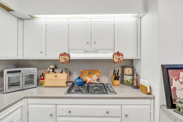 a kitchen with stainless steel appliances granite countertop a sink and cabinets